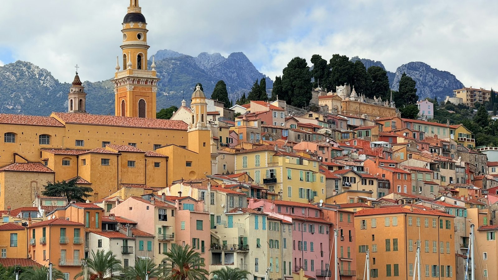 Menton's pastel old town and the Basilique Saint-Michel below the mountains in winter