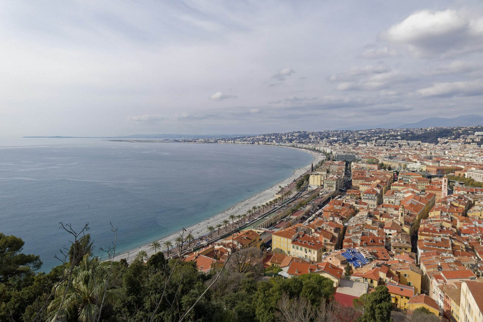 Terracotta rooftops of Nice with the Baie des Anges beyond